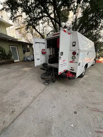 Magnet Plumbing service vehicle on-site for Slab Leak Repair in Apartment Row